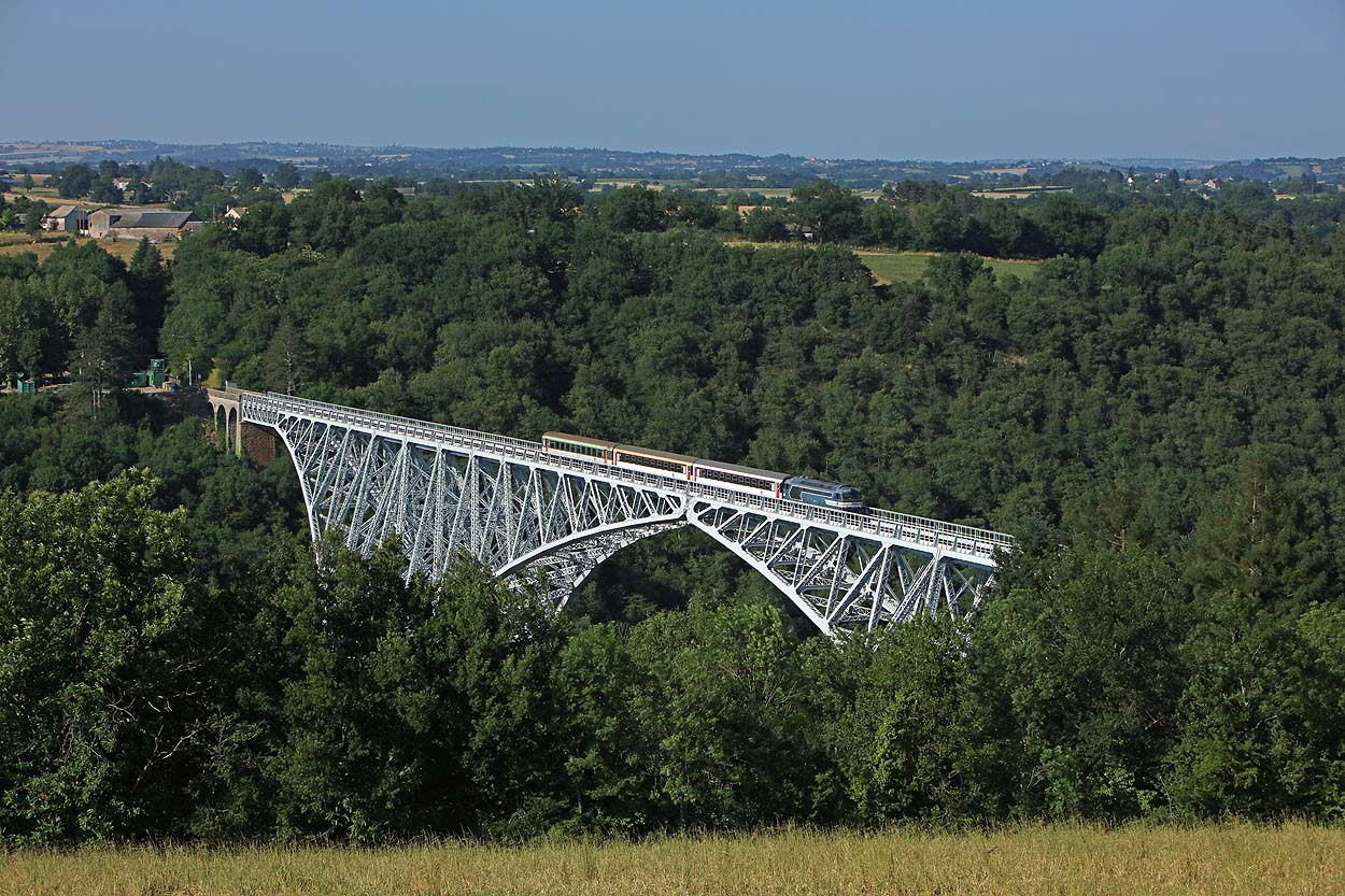 SNCF 567523 takes three empty sleeper coaches from Rodez to Albi Ville across the impressive Viaduc de Viaur (the first large steel bridge built in France completed in 1902) near Tanus on 18 June 2017.